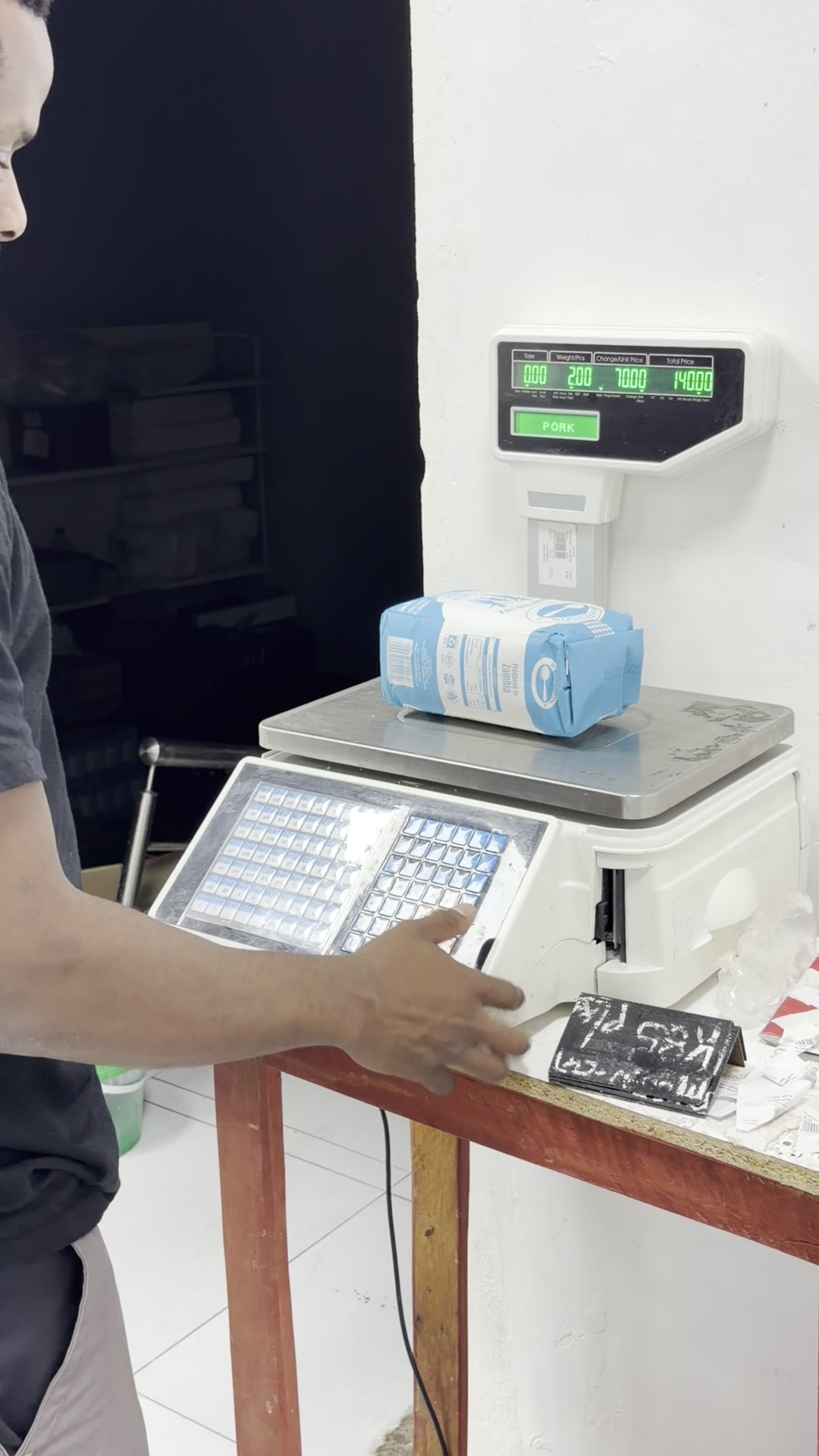 Weighing meat on the label scale in the Mongu shop